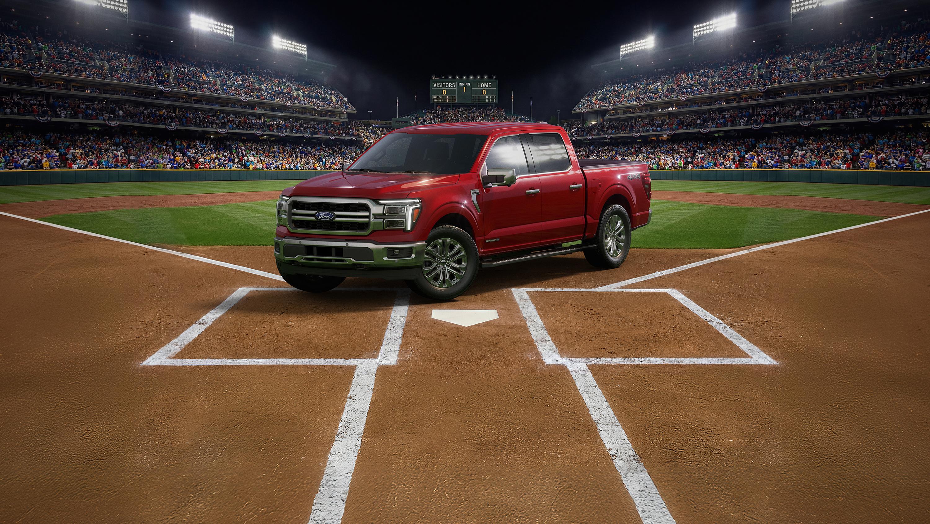 A red Ford F-150® parked at home plate of a baseball diamond