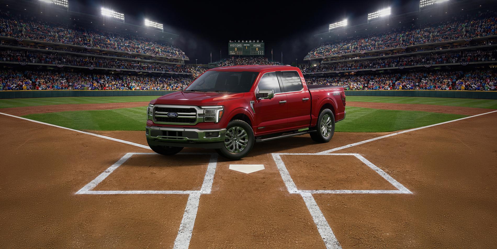 A red Ford F-150® parked at home plate of a baseball diamond