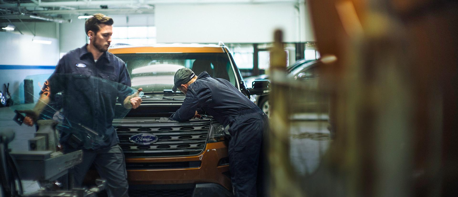 Ford technicians work on vehicles in a Certified Collision Center