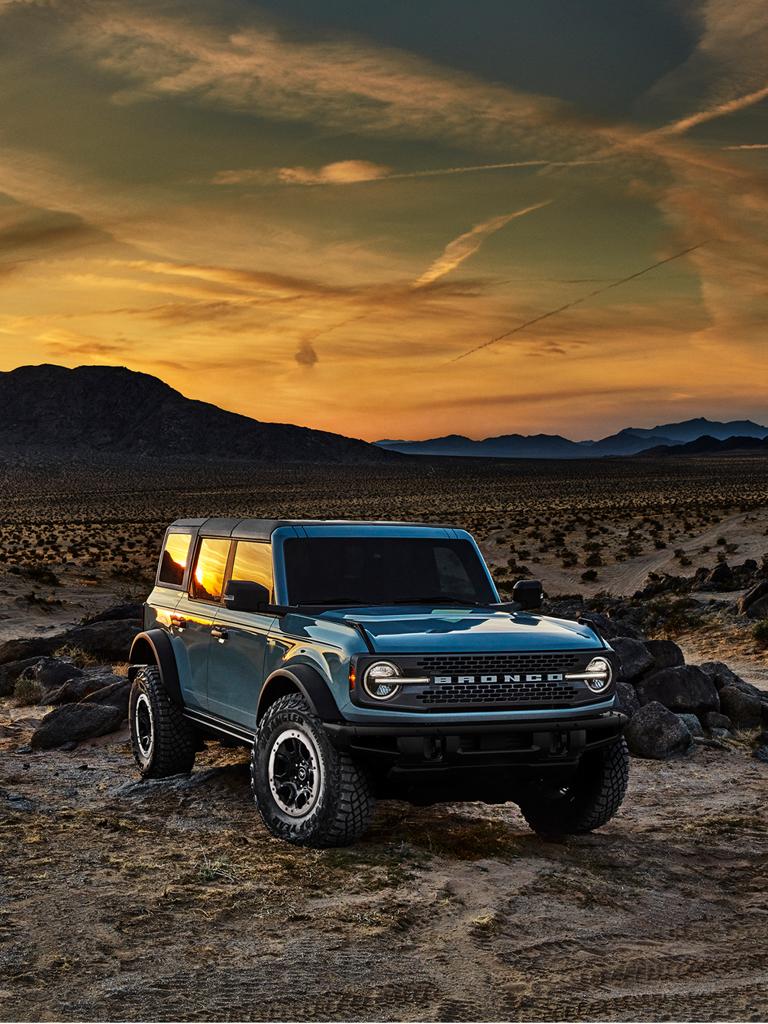 A blue Ford Bronco® SUV parked on rugged terrain
