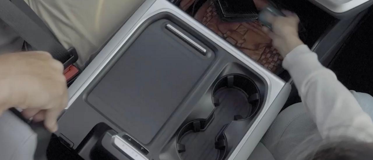 A driver and passenger using the available Flex Powered Console in a 2027 Ford Expedition® SUV