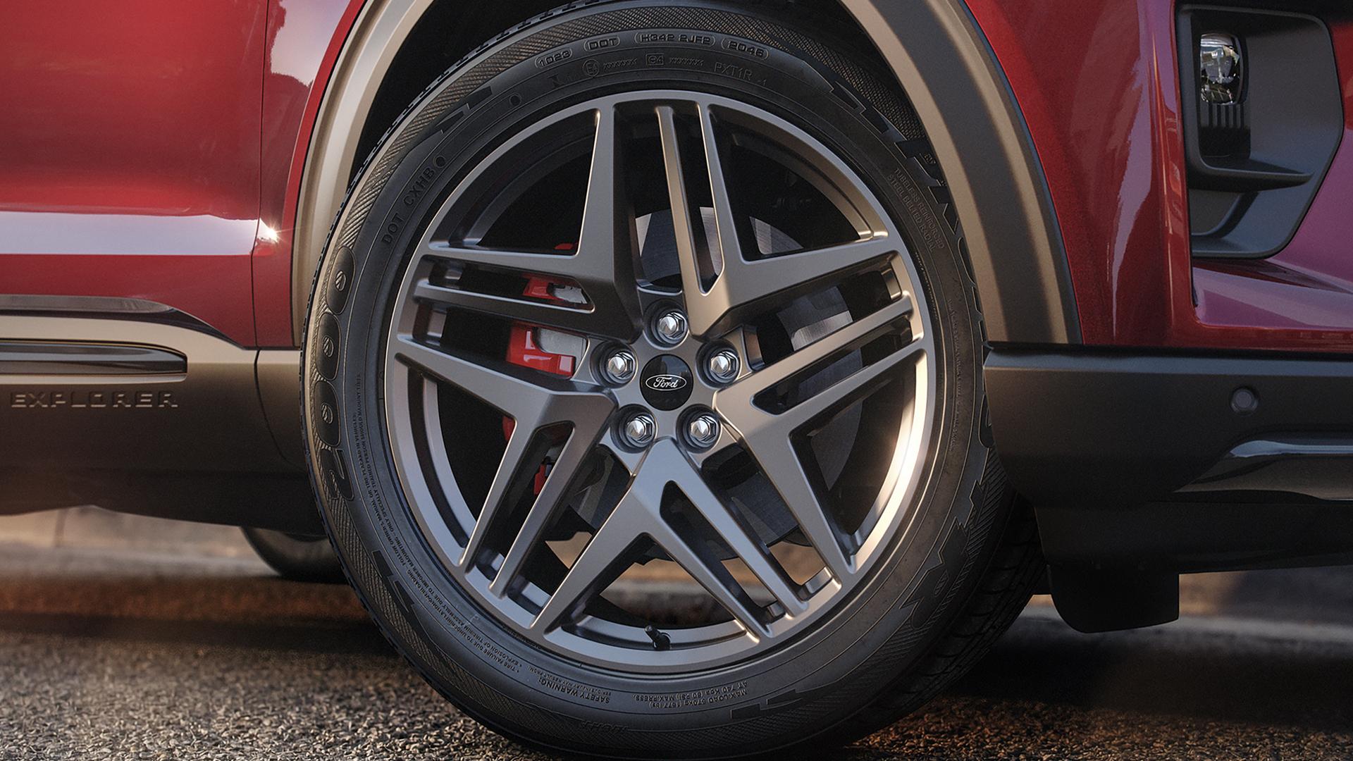 The front wheel of a 2027 Ford Explorer® ST-Line with available ST-Line Street Pack, showing the red-painted brake calipers