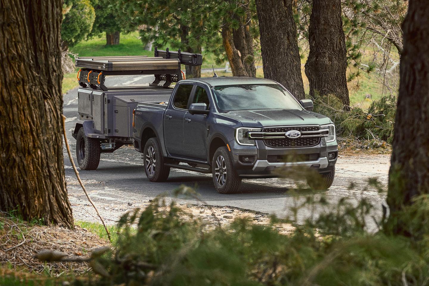 2026 Ford Ranger® truck pulling a large trailer on a paved road