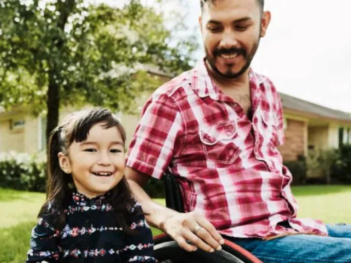 Man in a wheelchair with a child