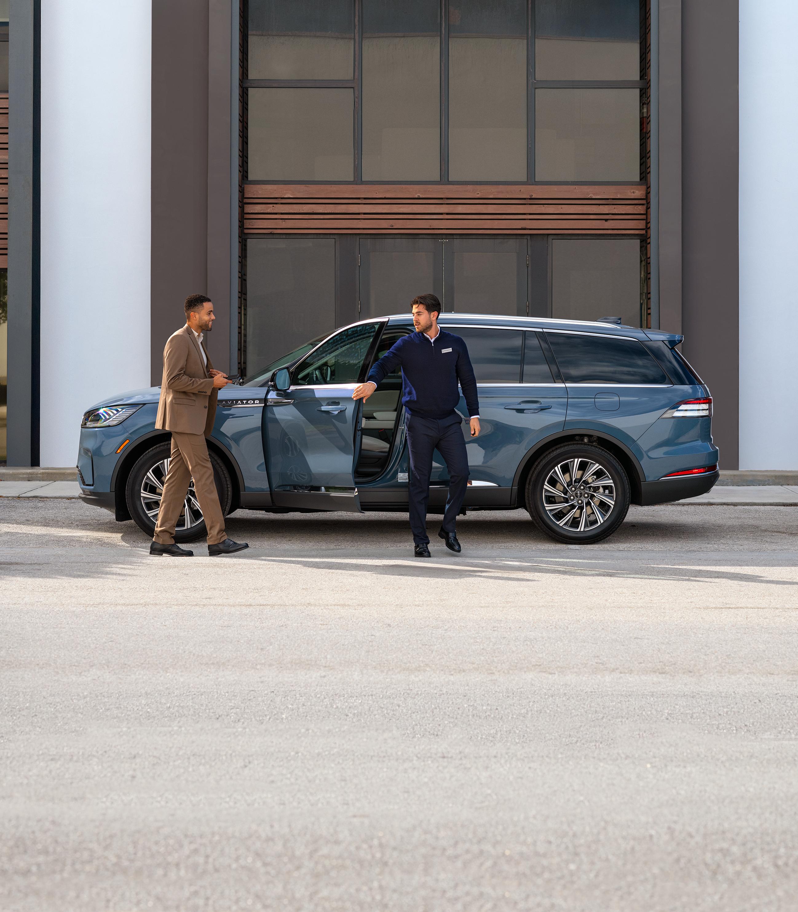 A Lincoln employee dropping off a Lincoln vehicle to its owner.