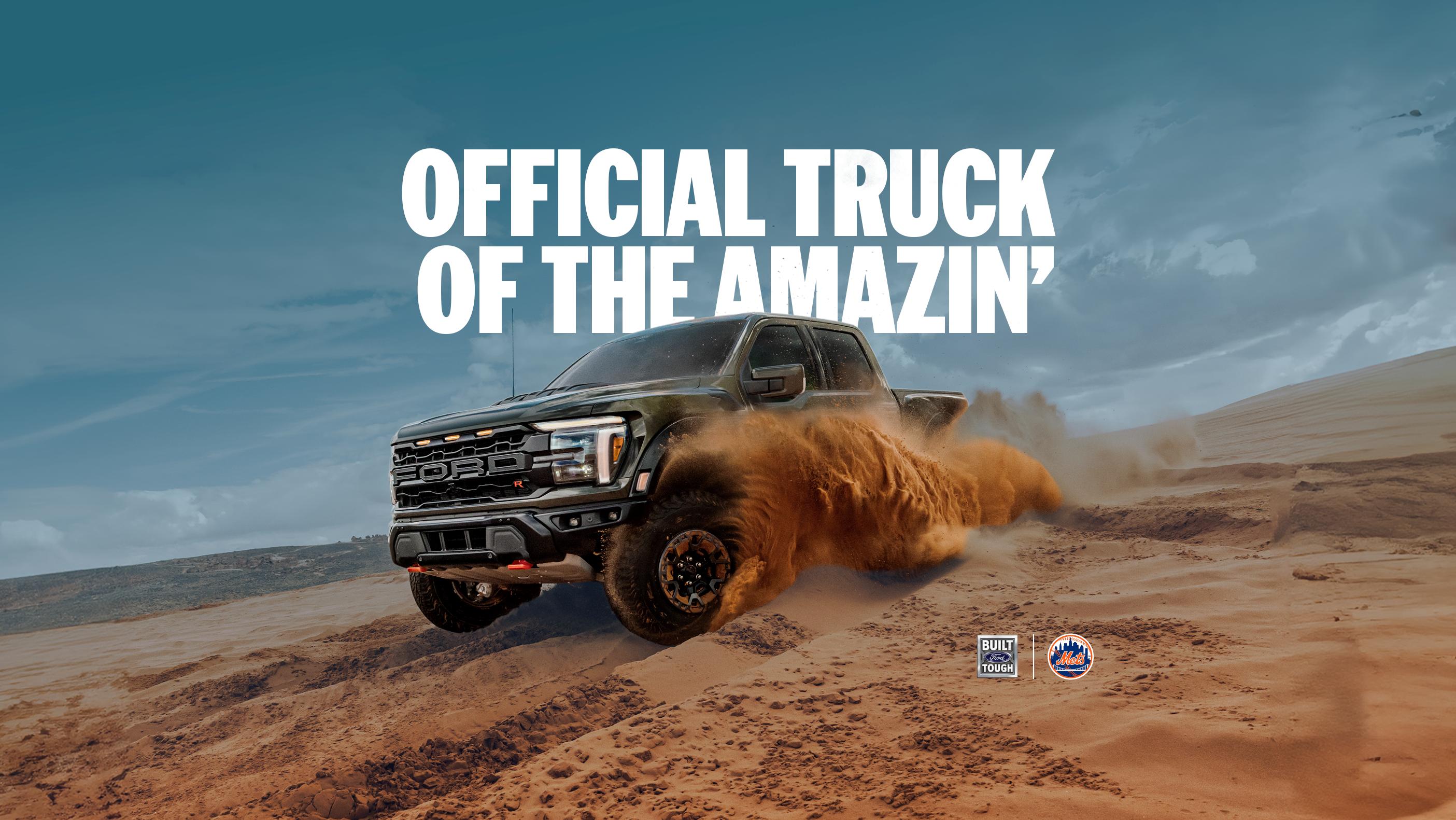 A black Ford F-150® Raptor Truck is being driven in the desert, kicking up sand. 