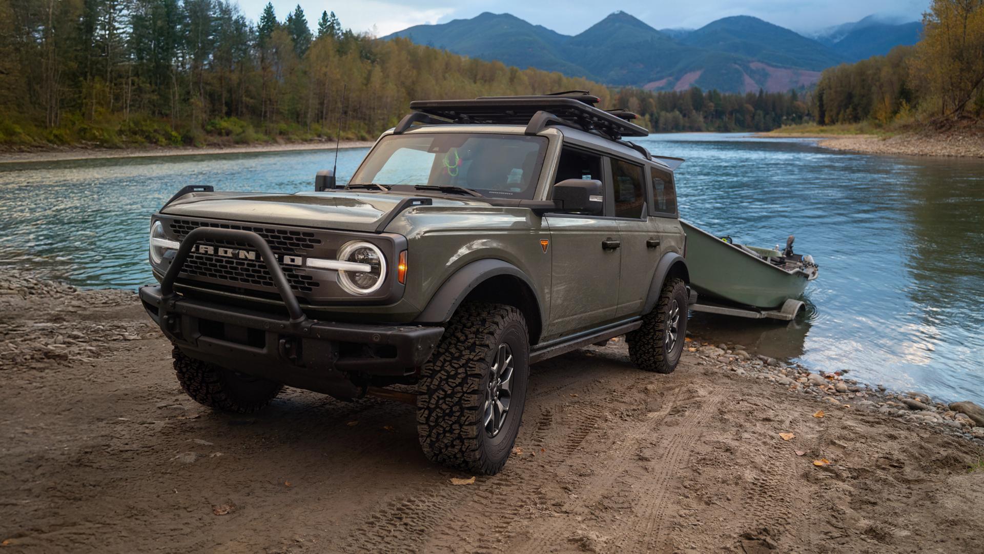 A 2026 Ford Bronco® SUV pulling a boat on a trailer out of a lake