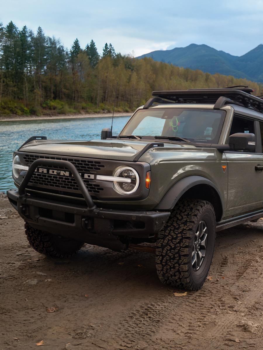 A 2026 Ford Bronco® SUV pulling a boat on a trailer out of a lake