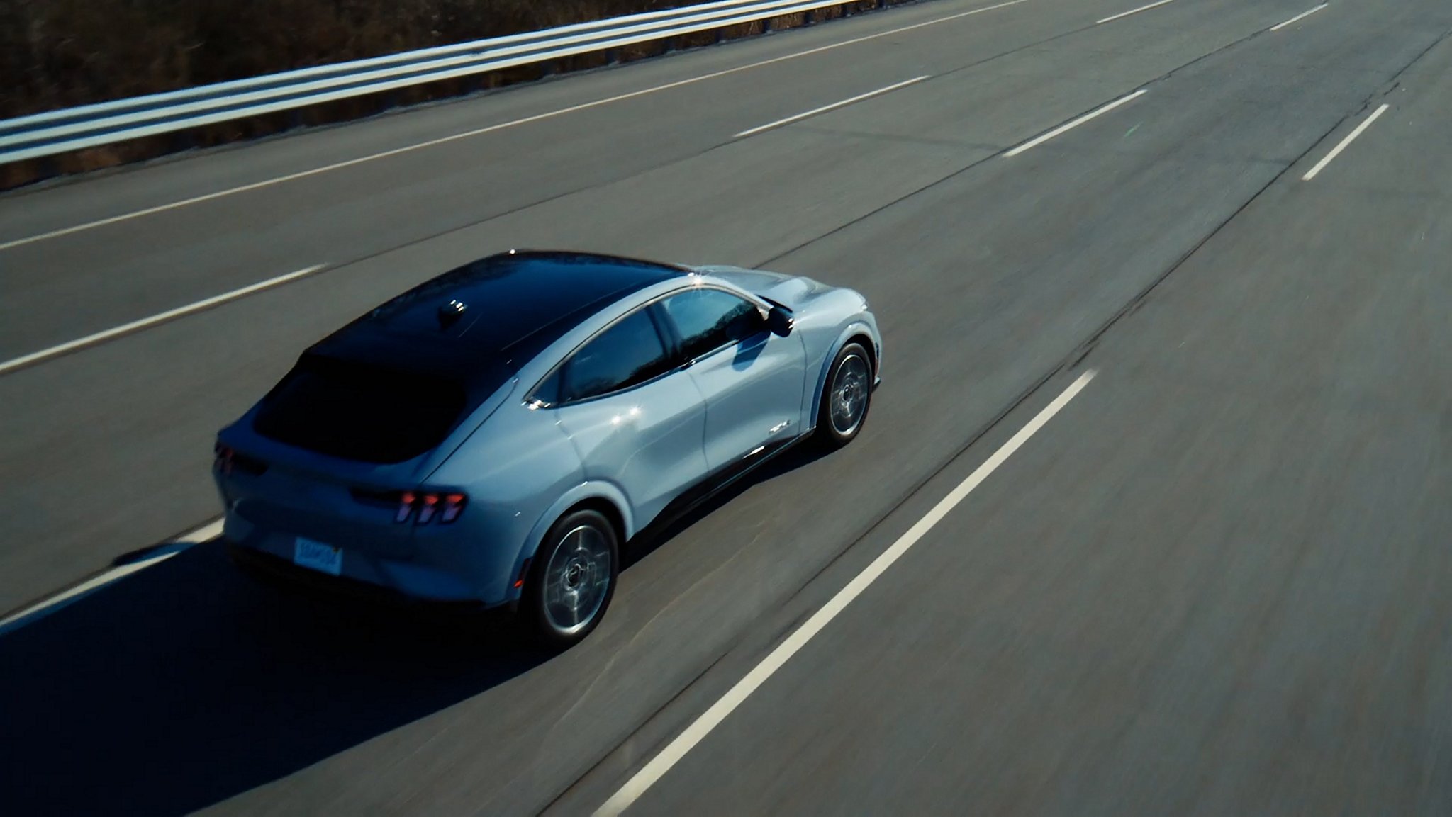 Overhead view of a 2025 Ford Mustang GT model being driven on a five-lane highway