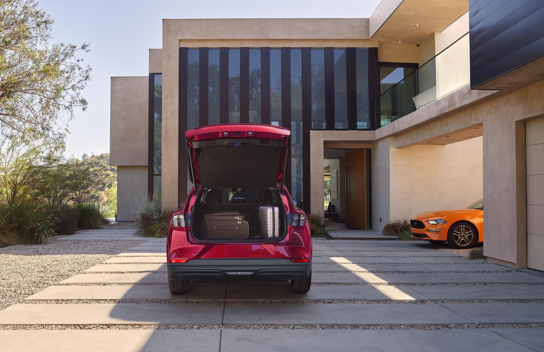 Cargo space of a 2025 Ford Mustang Mach-E® parked in the driveway of a luxury home
