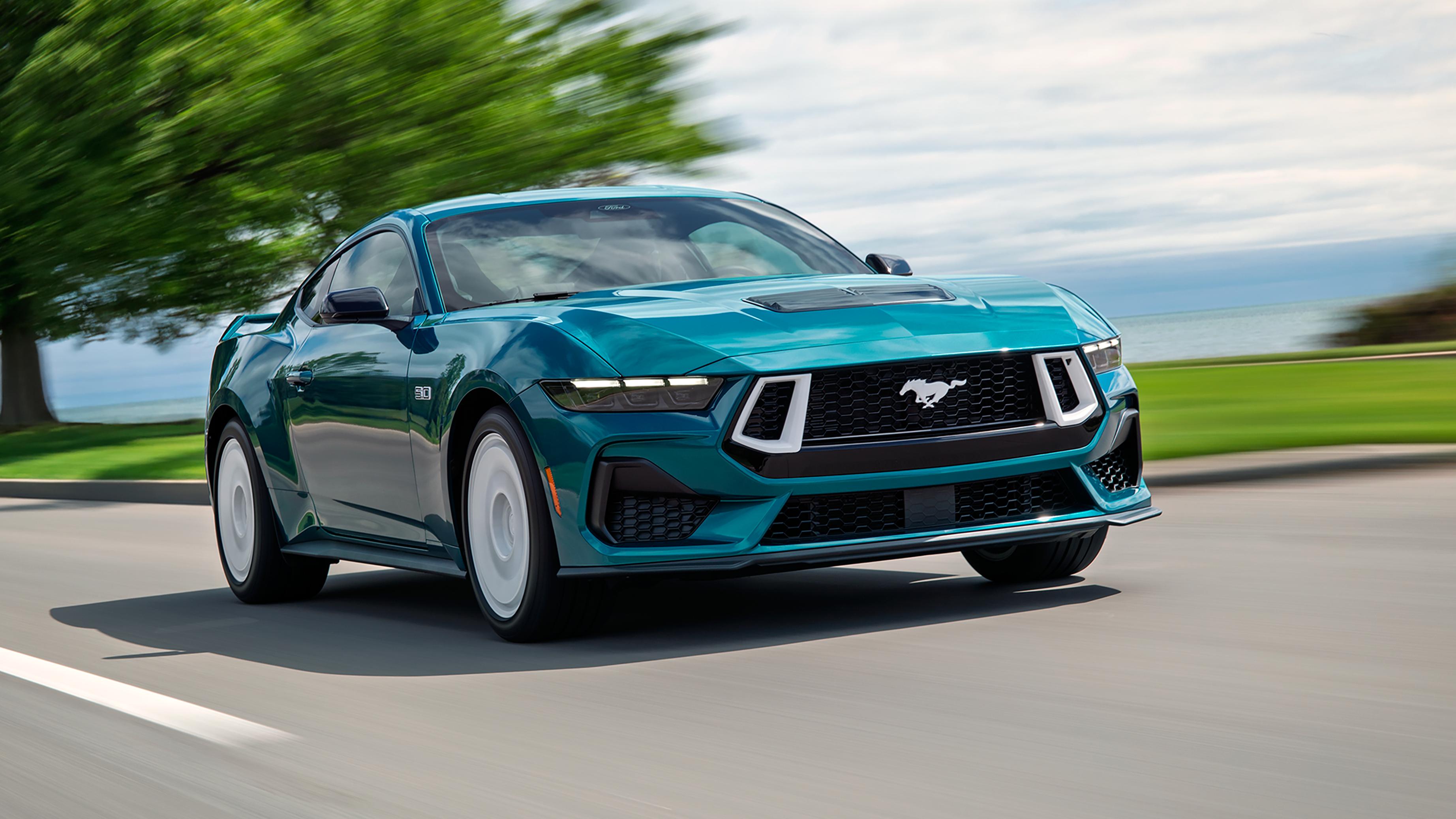 A 2026 Ford Mustang® GT Premium with the available Mustang FX® Package being driven near a lake