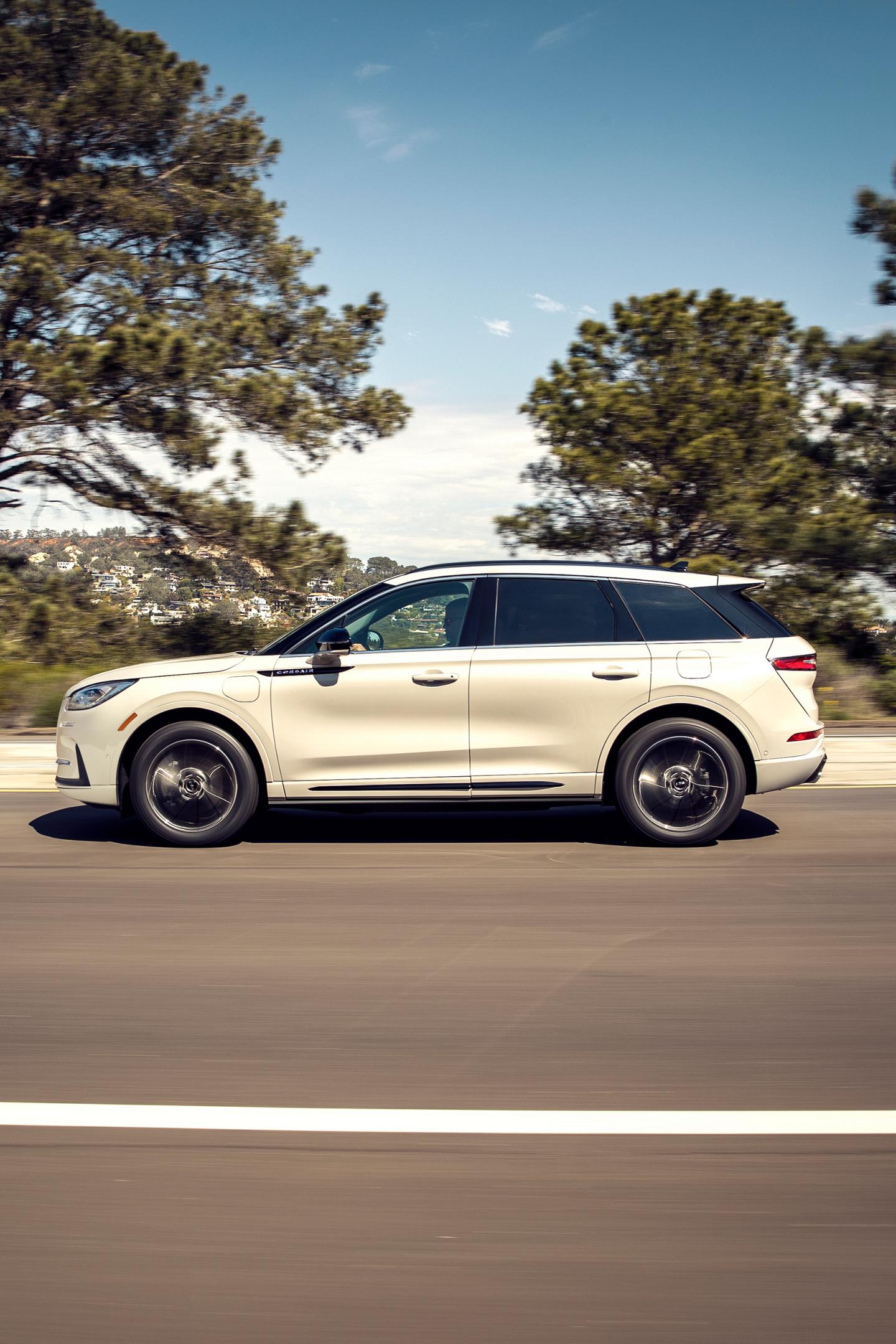 A 2025 Lincoln Corsair Grand Touring plug-in hybrid is being driven in the countryside