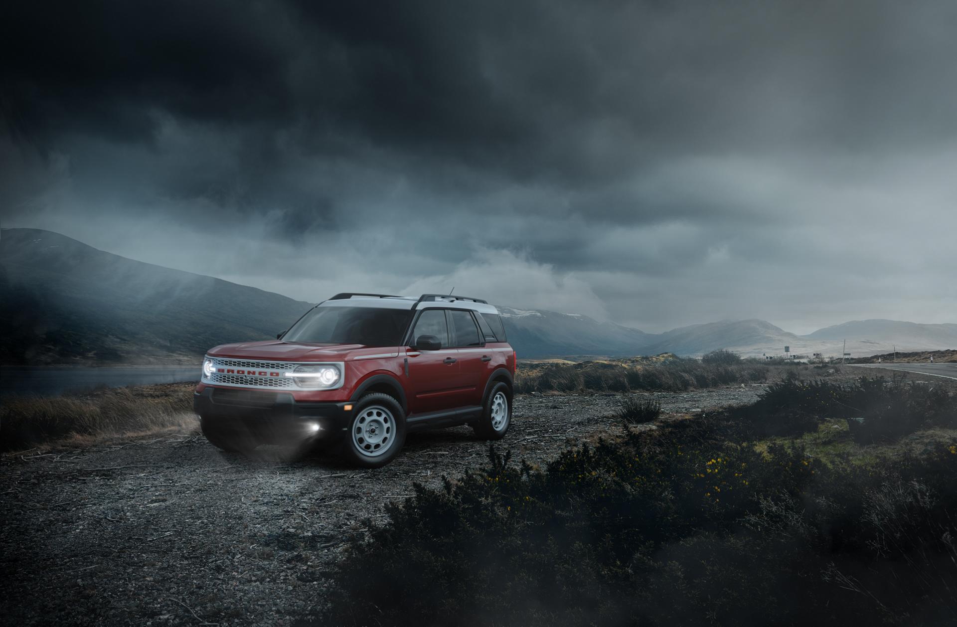 2026 Ford Bronco Sport® parked on a dirt road with dark clouds and mountains in the background