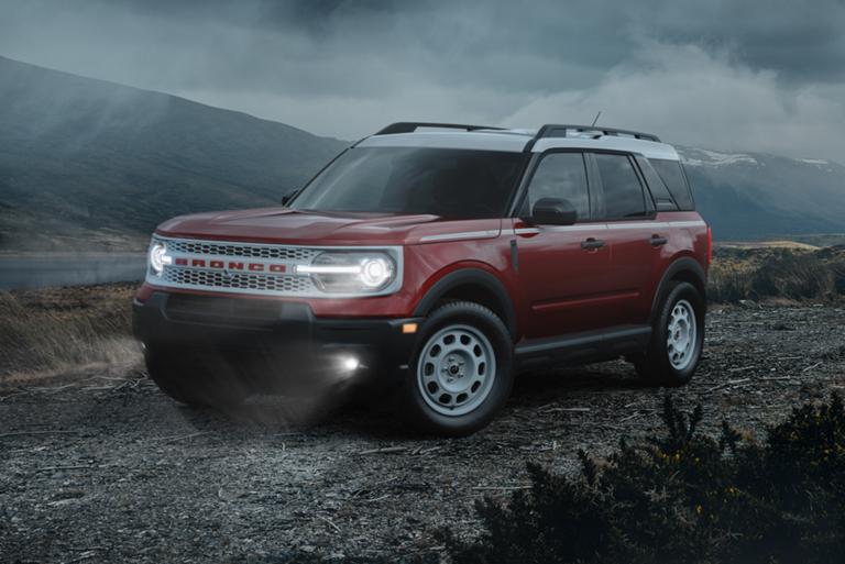 2026 Ford Bronco Sport® parked on a dirt road with dark clouds and mountains in the background