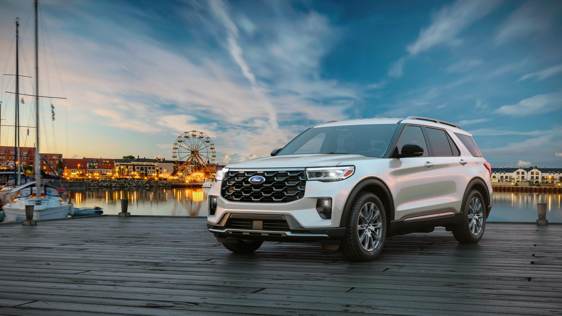 A 2026 Ford Explorer® SUV parked on a pier near an amusement park