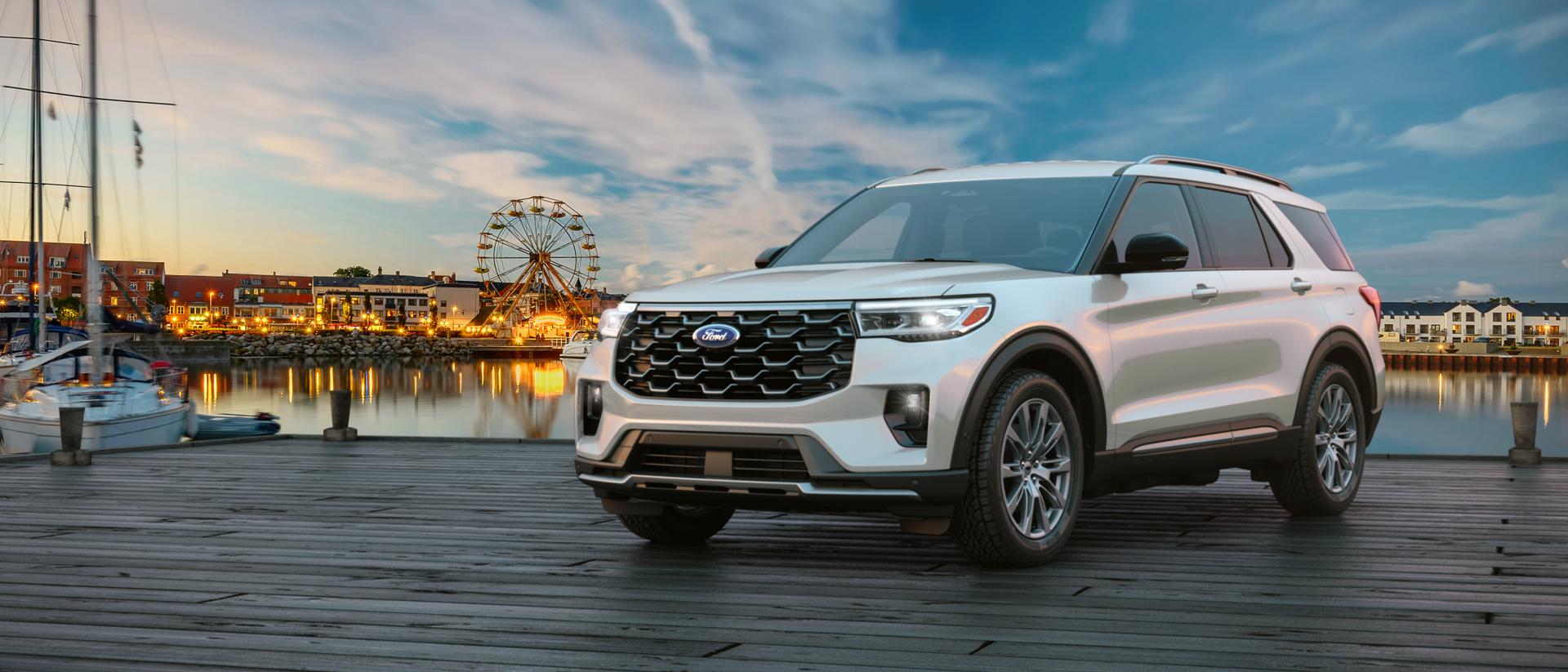 A 2026 Ford Explorer® SUV parked on a pier near an amusement park