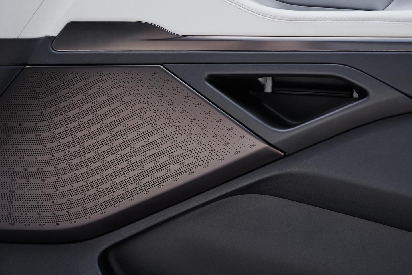 A Revel® Ultima 3D Audio System speaker positioned in the front passenger door