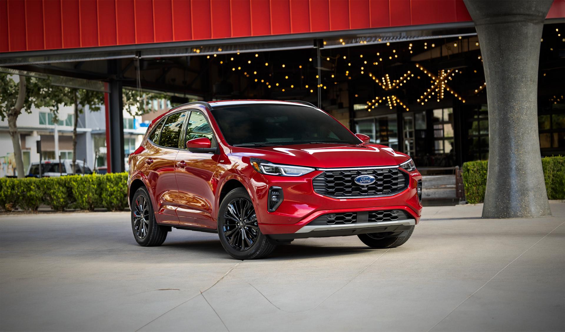 Red 2024 Ford Escape® SUV parked in front of a building with string lights