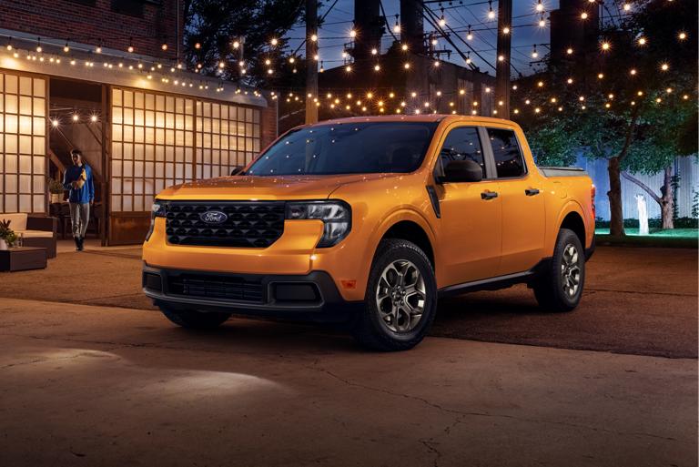2026 Ford Maverick® parked outside a building at night with string lights in the background