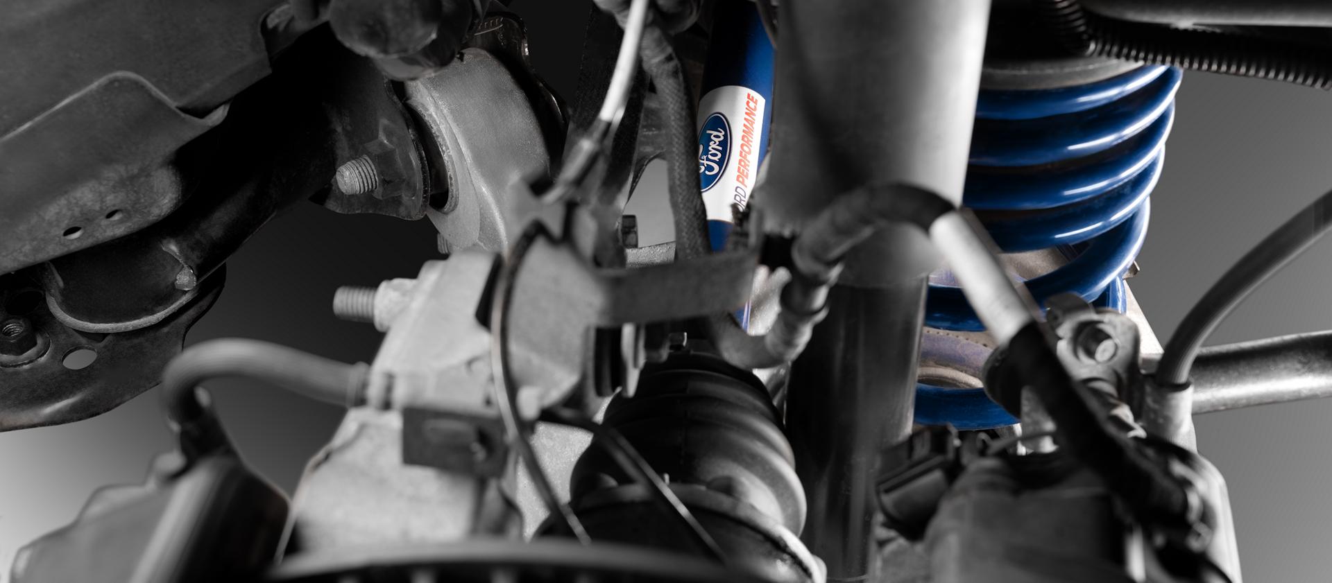 Front suspension detail showing the street lowering kit coil-over spring