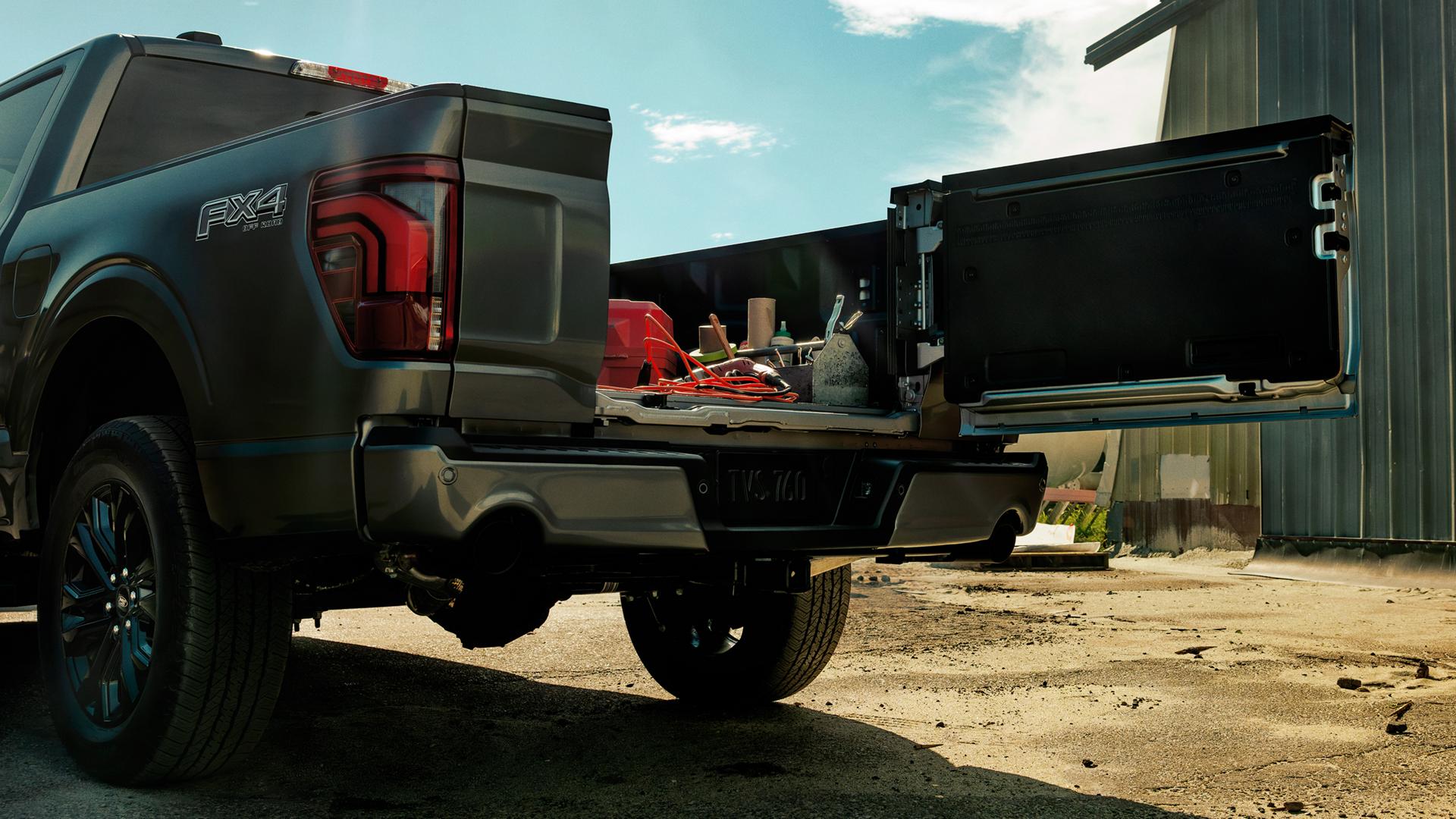 Close-up of the Pro Access tailgate on a 2026 Ford F-150® truck opened showing tools and items in the truck bed