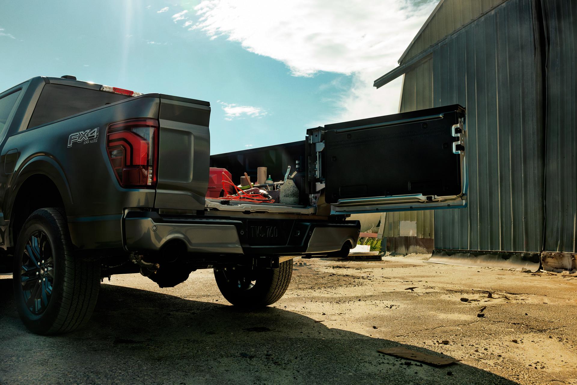 Close-up of the Pro Access tailgate on a 2026 Ford F-150® truck opened showing tools and items in the truck bed
