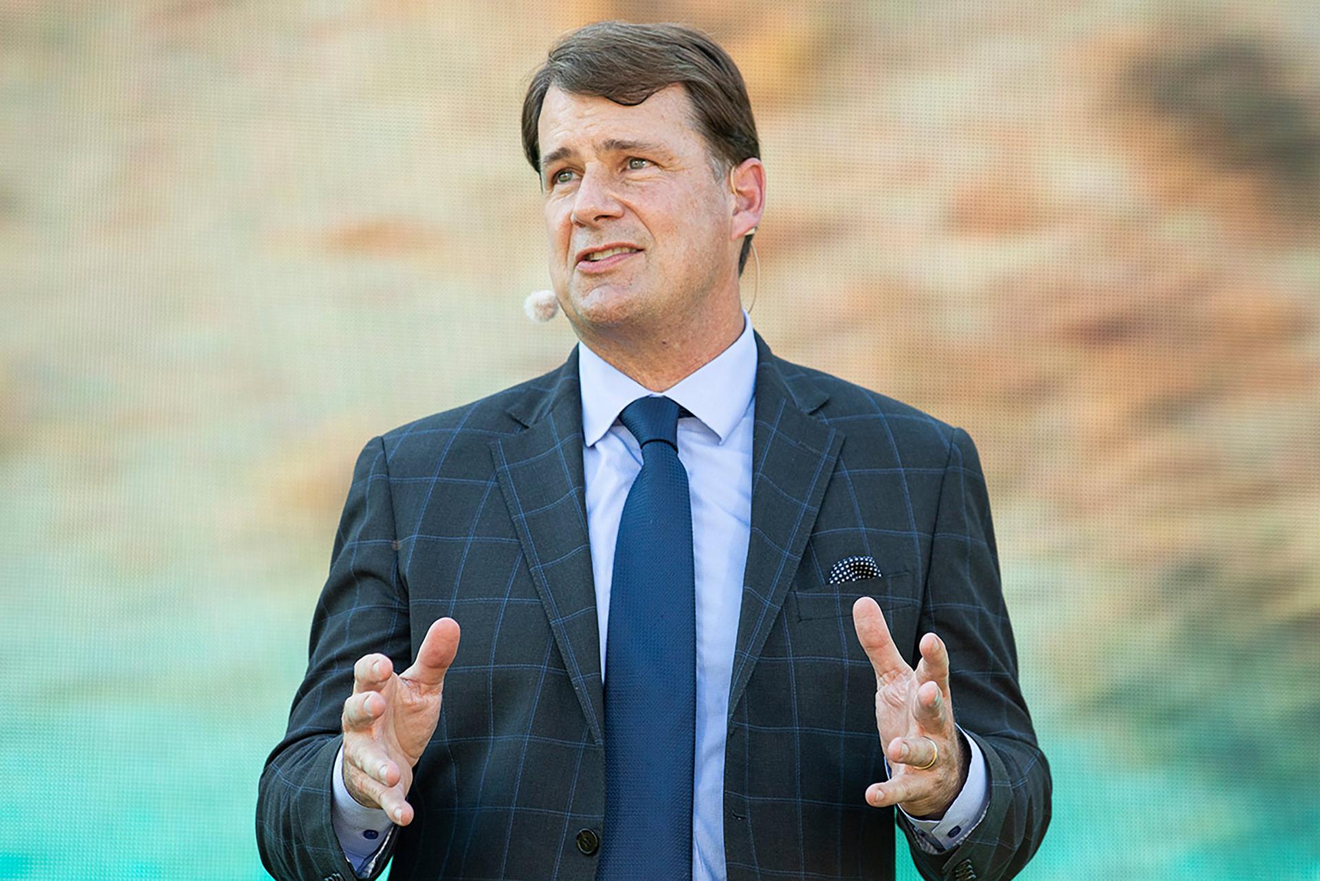 A portrait of Jim Farley delivering a speech