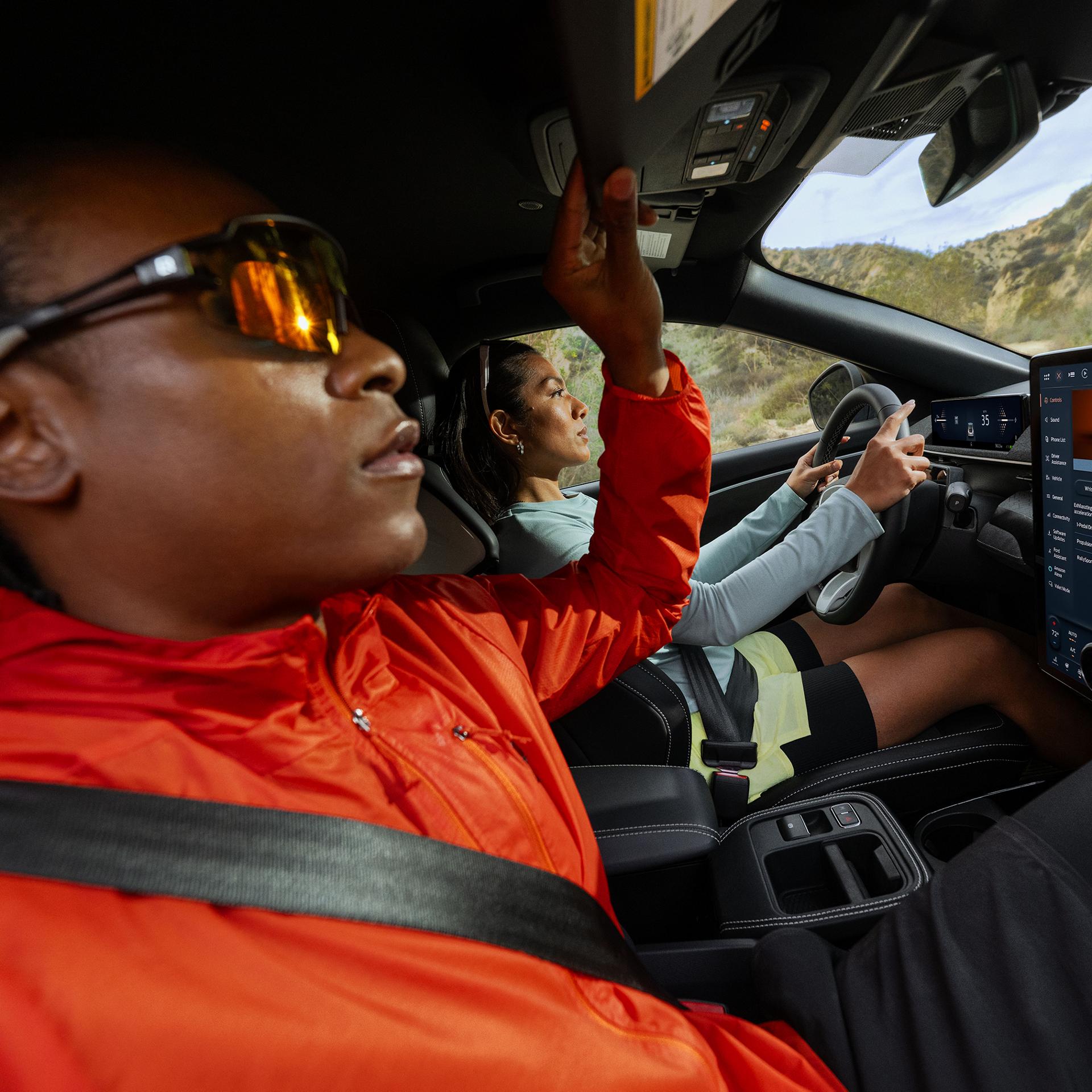 Two people sitting in the front of a 2025 Ford Mustang Mach-E® Rally