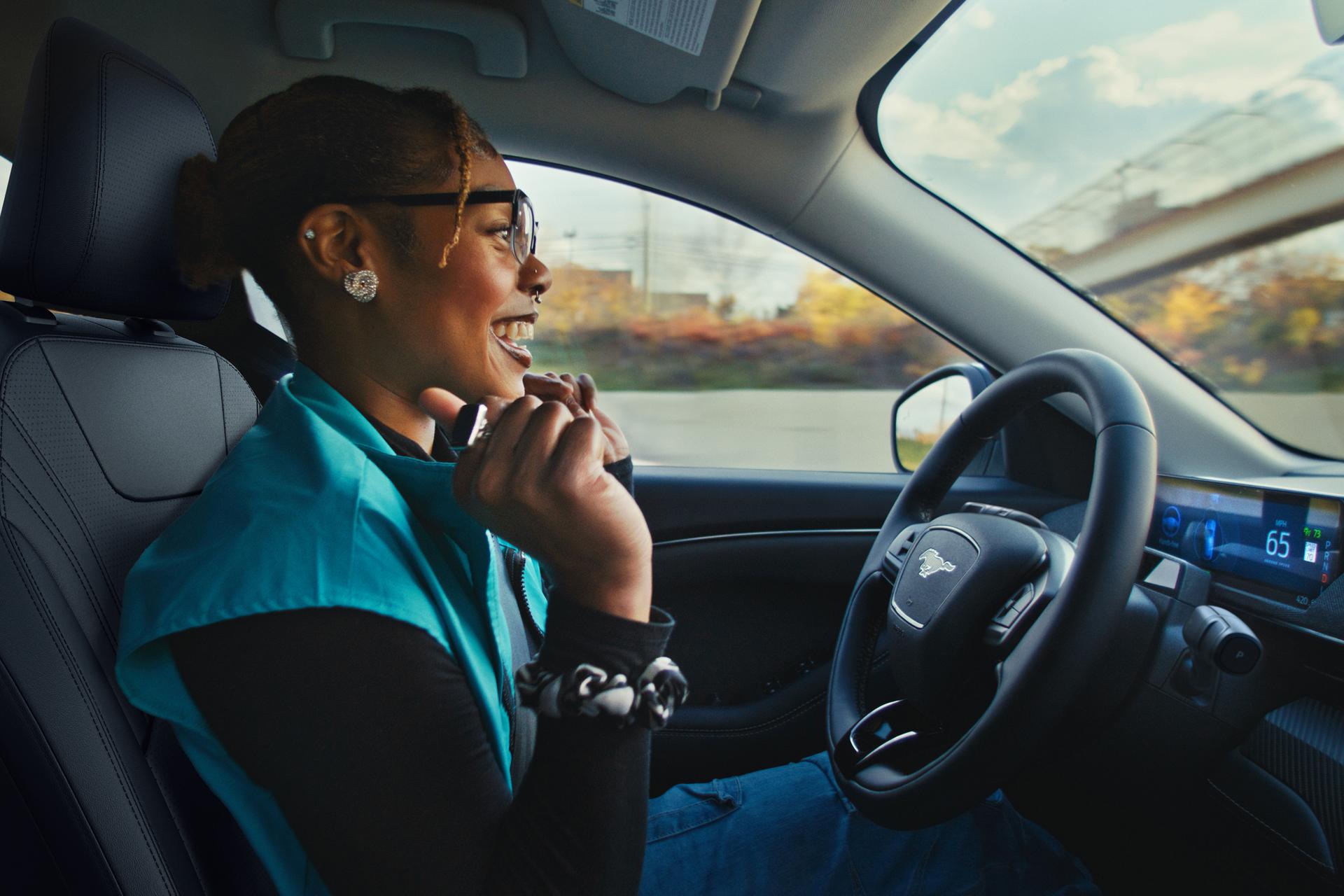 Driver seated in a Ford vehicle using BlueCruise hands‑free driving technology