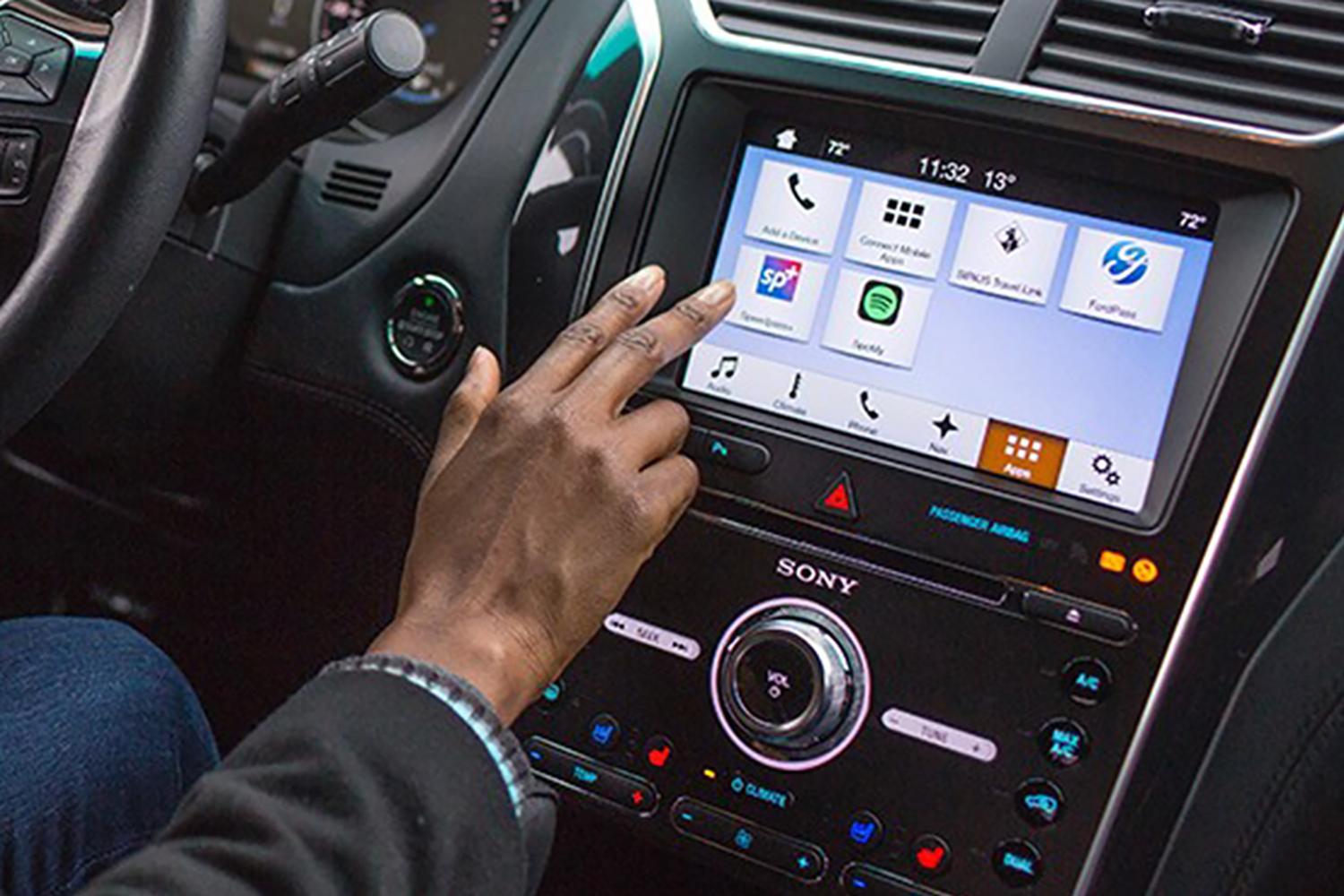 A driver uses the center display to select a feature