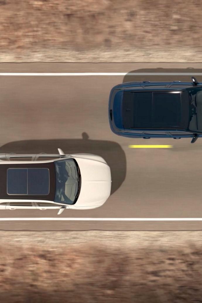 Two vehicles are shown from overhead to demonstrate the Blind-Spot Information System