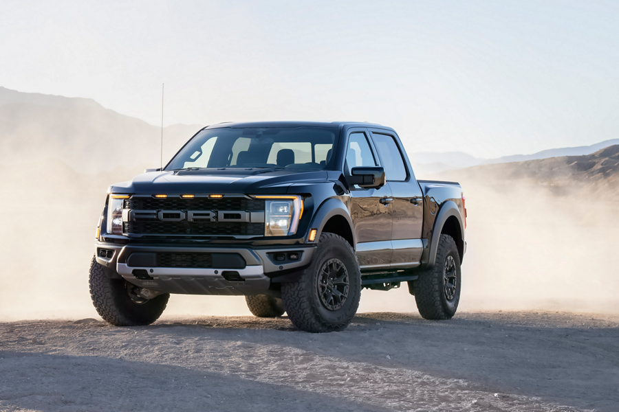 2022 Ford F-150® Raptor® in Agate Black parked in the desert with dust blowing