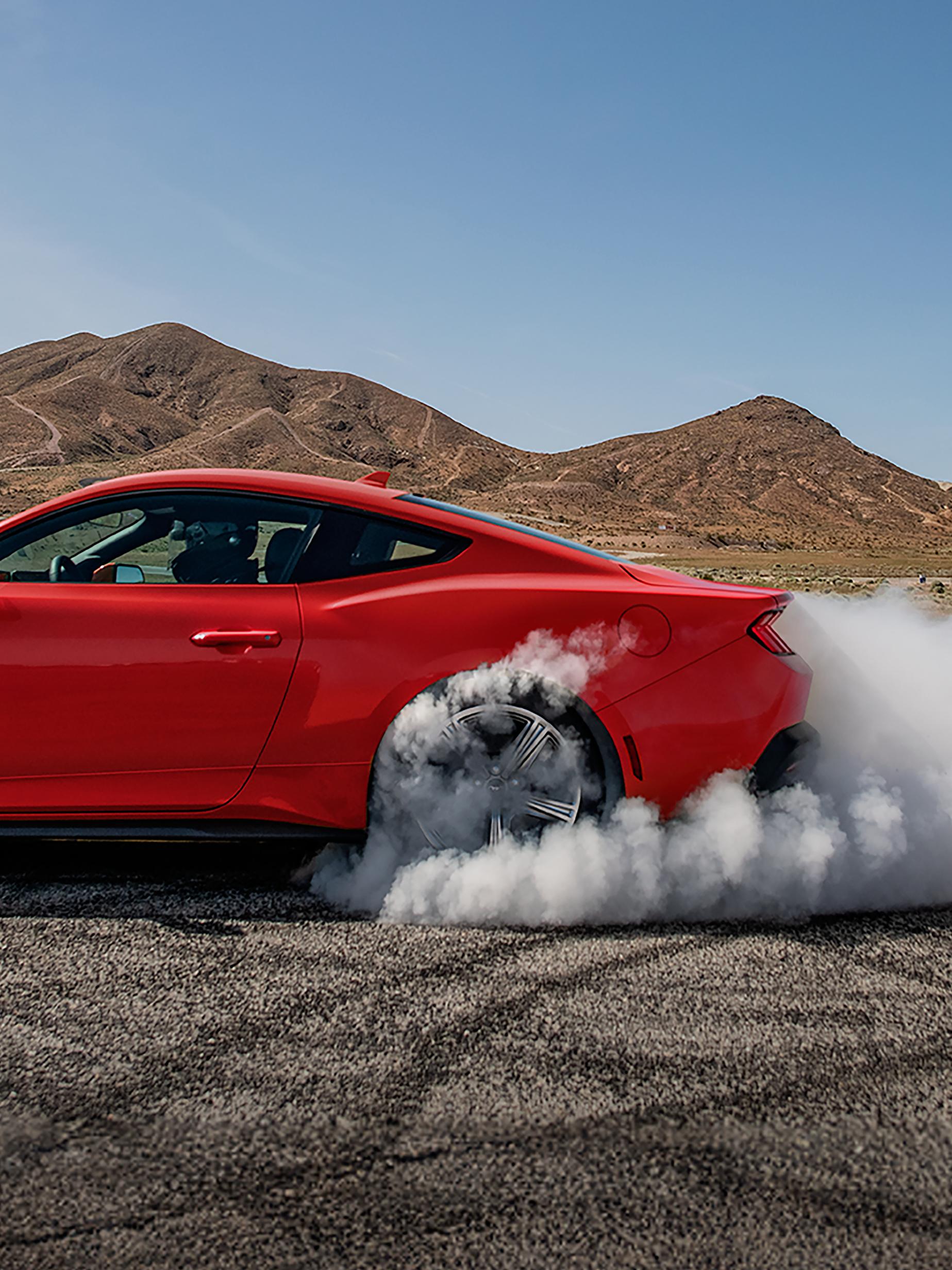 2026 Ford Mustang® EcoBoost® fastback in with a driver doing burnouts on a closed course 