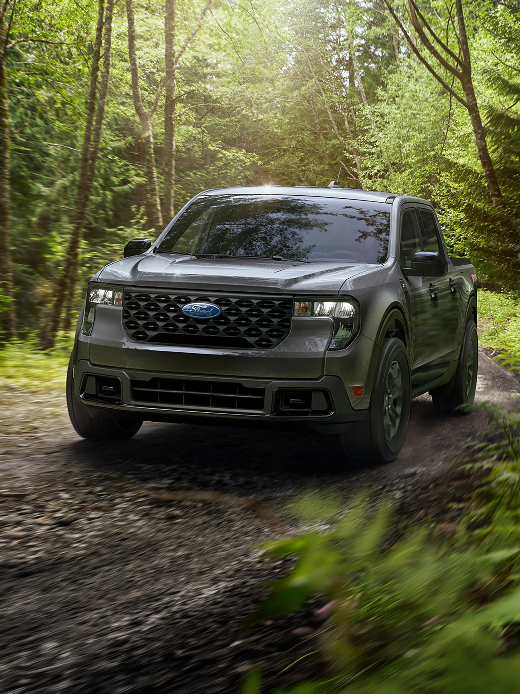 2026 Ford Maverick® model being driven on a wooded dirt road