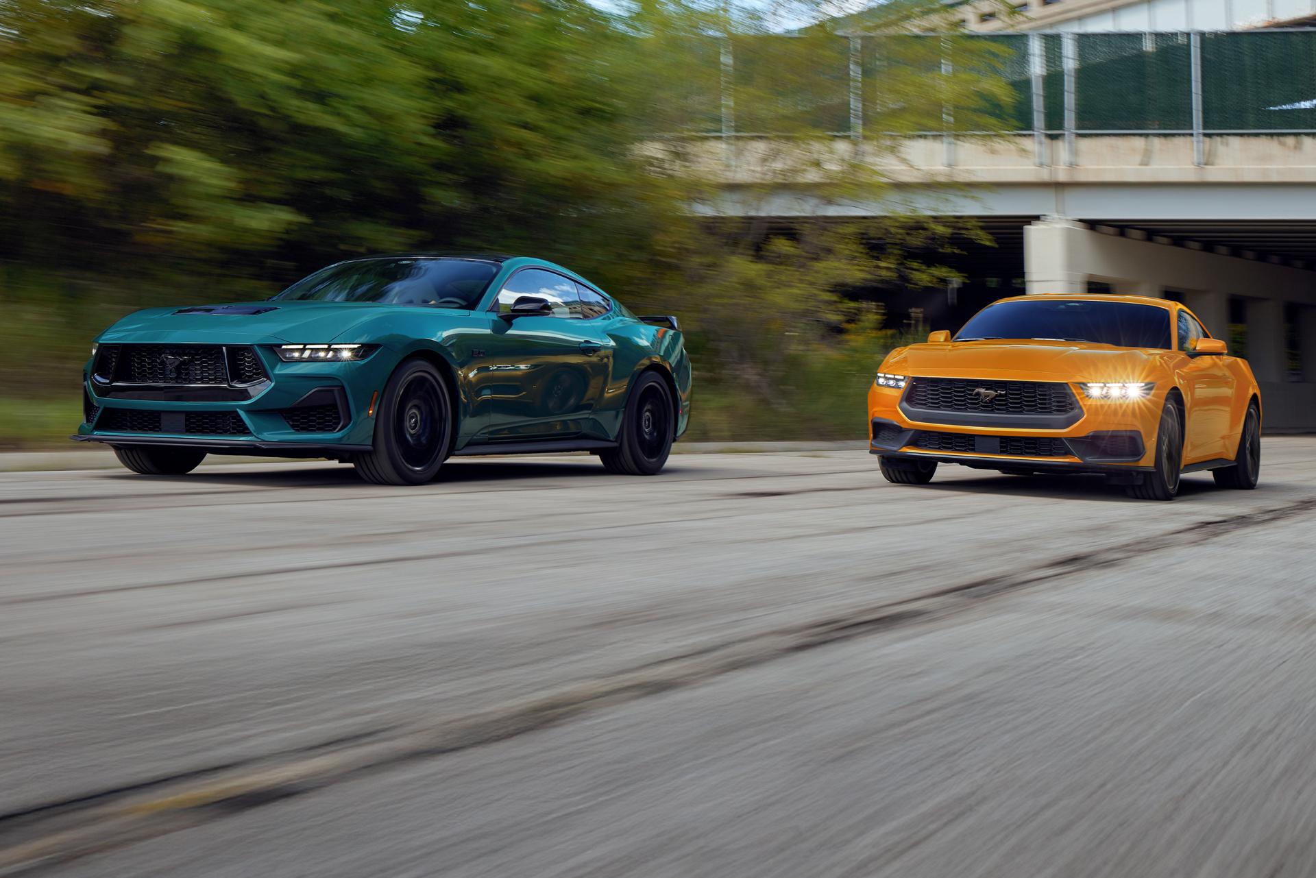 Two Mustang® cars being driven along a city road