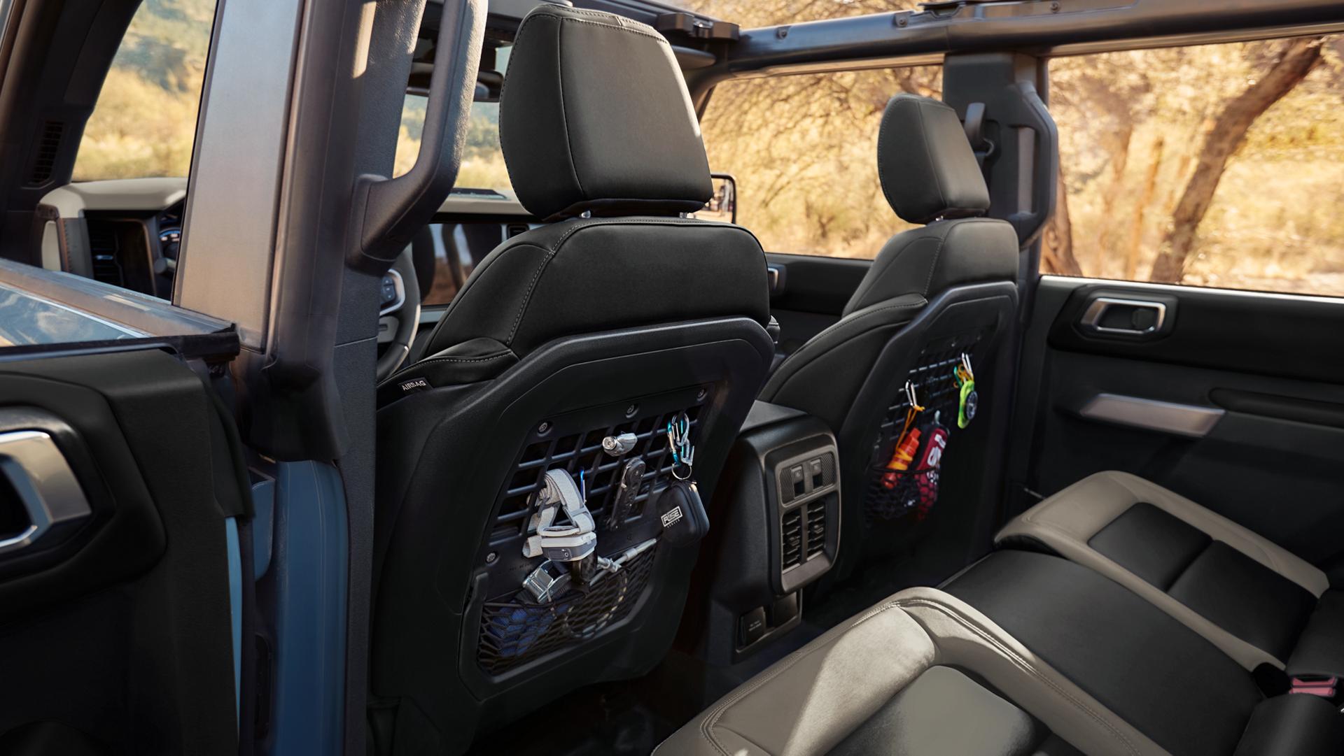 The rear seat area of a 2025 Ford Bronco® SUV, showing the MOLLE panels in the front seat backs