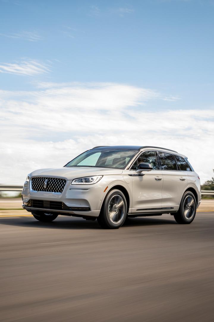 A 2025 Lincoln Corsair Grand Touring plug-in hybrid is being driven on a mountain road