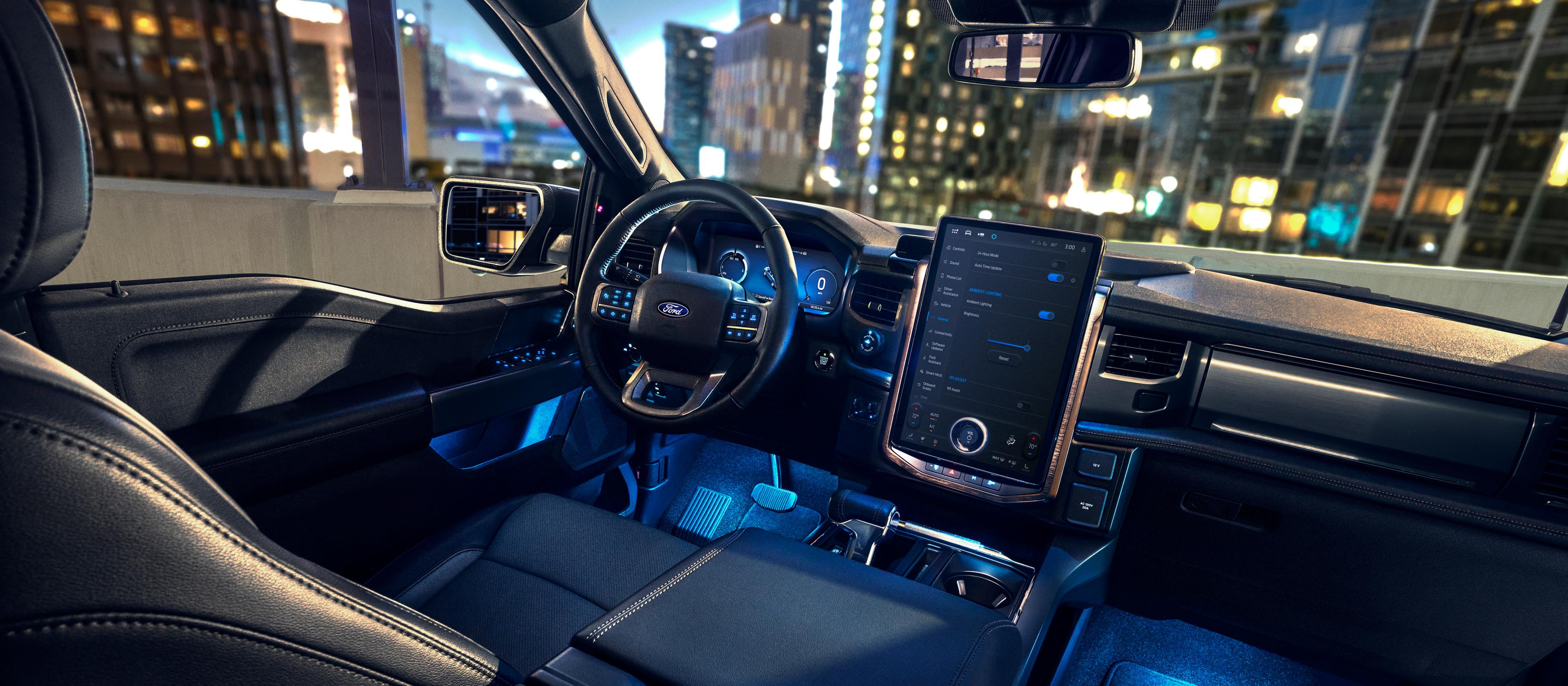 The dashboard and instrument panel of a 2025 Ford F-150® Lightning® pickup, with LED illumination in the footwells