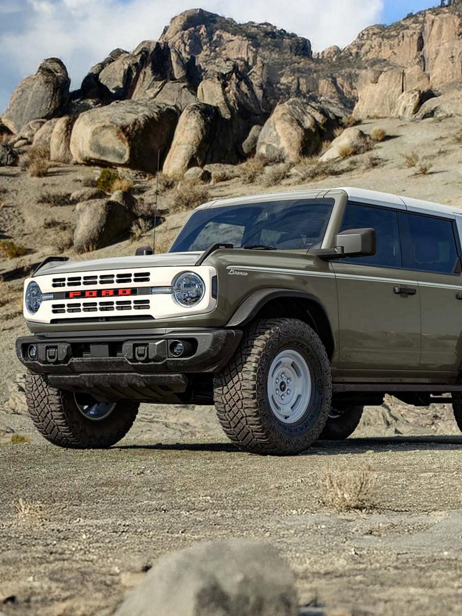 A 2026 Ford Bronco® Heritage Edition SUV parked on a mud flat, with a rocky cliff behind