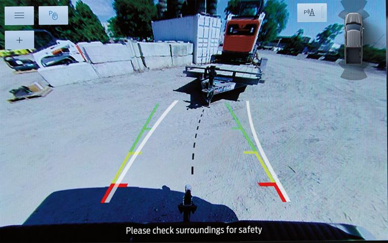 The center display of a 2026 Ford F-150® pickup with the Dynamic Hitch Assist guidelines on screen