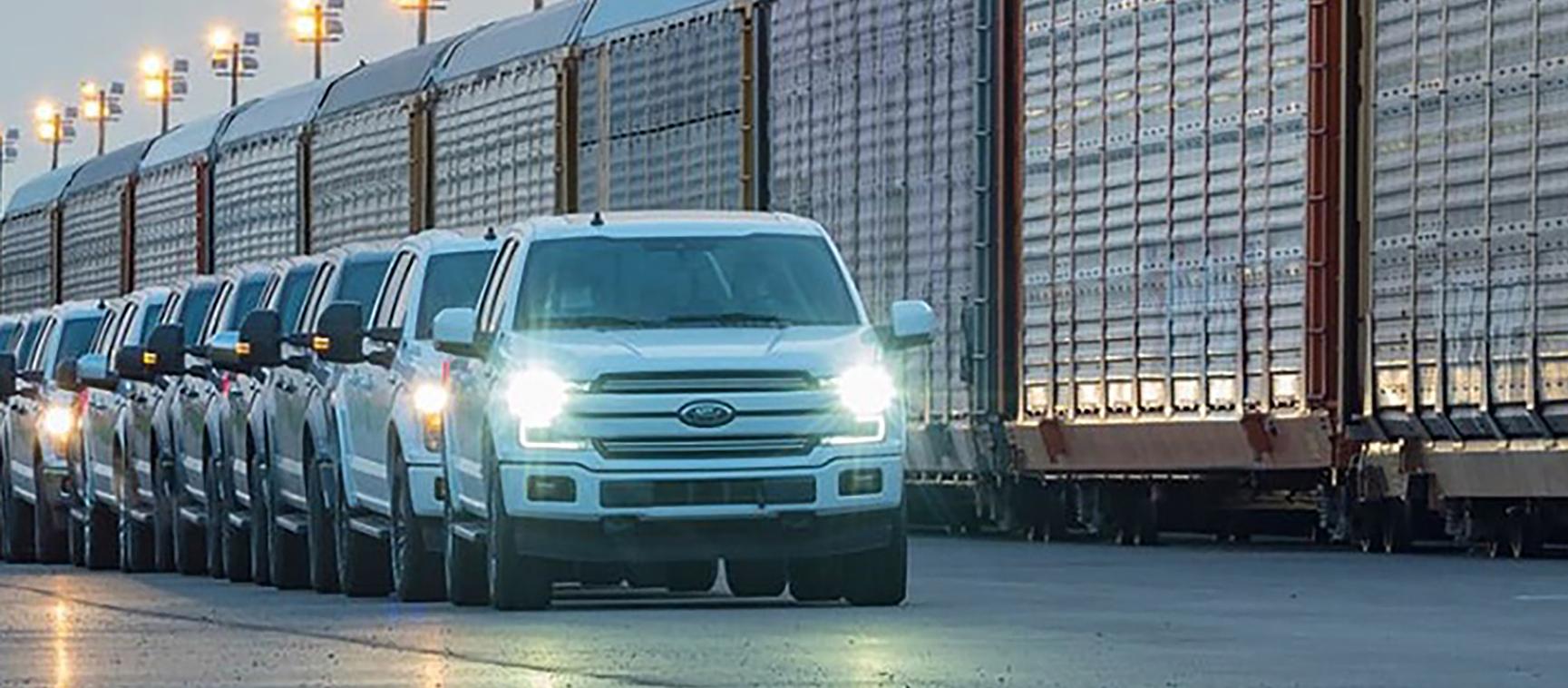 Ford F-150s in front of train