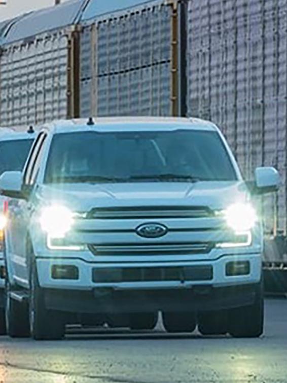 Ford F-150s in front of train