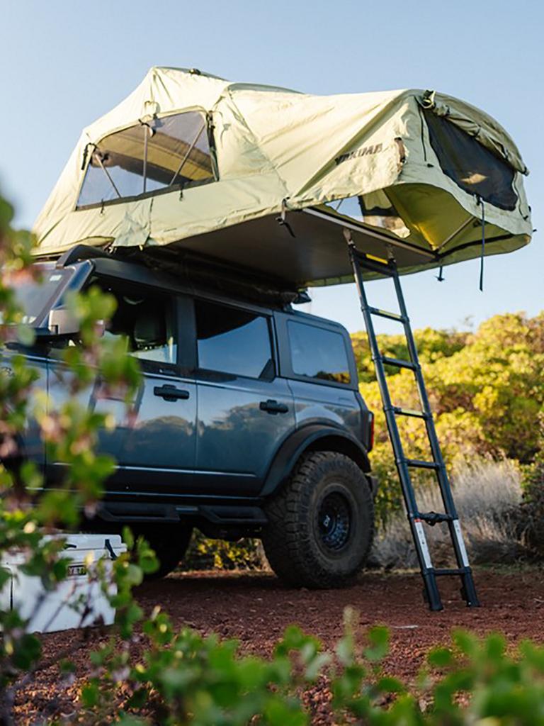 A Ford Bronco® SUV at a campsite with a rooftop tent