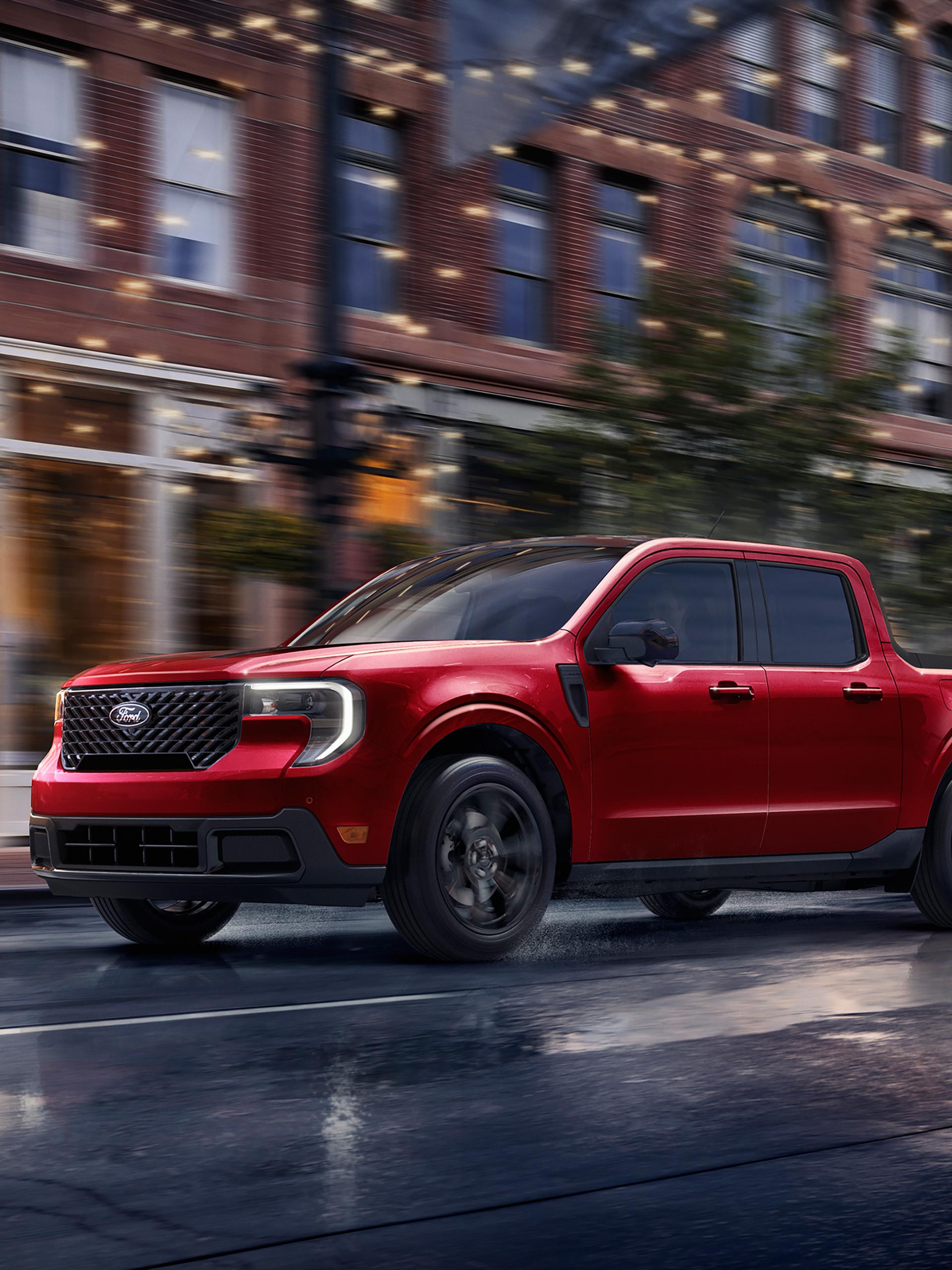 2026 Ford Maverick® pickup with Black Appearance Package being driven on a city street in the evening