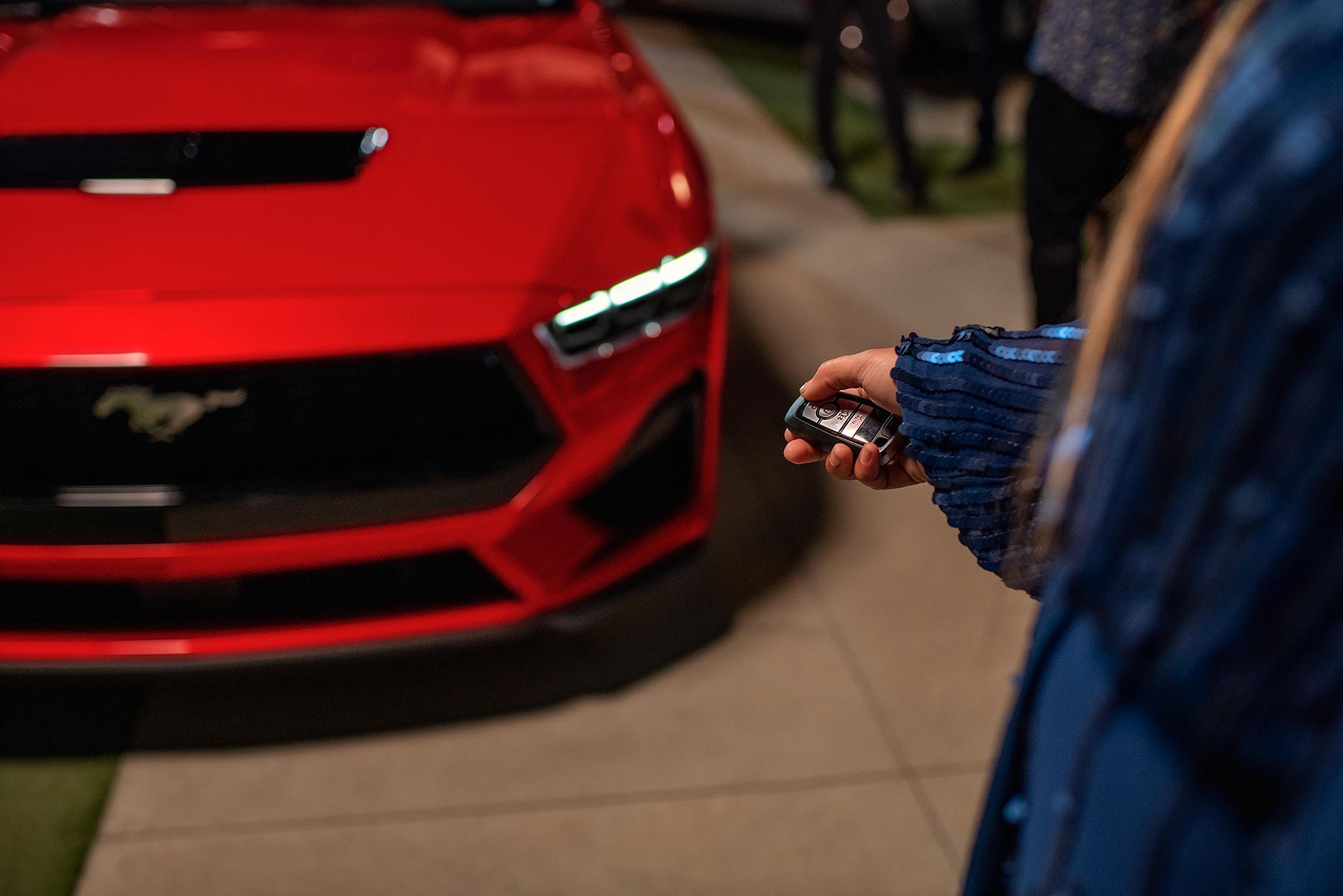 Person using the remote rev feature on a 2026 Ford Mustang® fastback with available automatic transmission