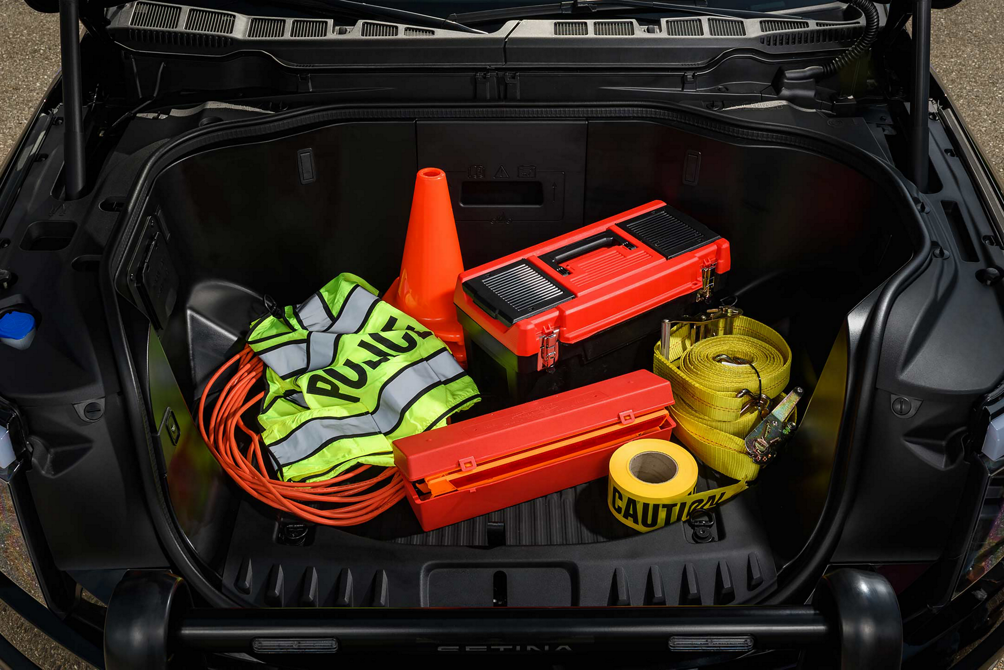 2023 Ford F-150®️ Lightning™️ Pro SSV frunk filled with law enforcement equipment like police vest, traffic cones, caution tapes and wires