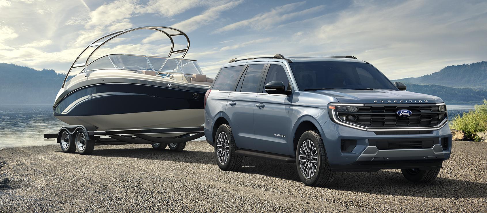 2026 Ford Expedition® Platinum® model with a driver towing a boat on a trailer