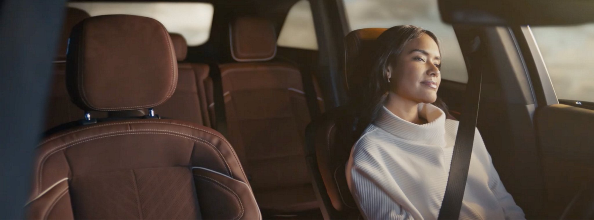 The driver of a parked 2025 Lincoln Black Label Nautilus SUV takes a relaxing moment