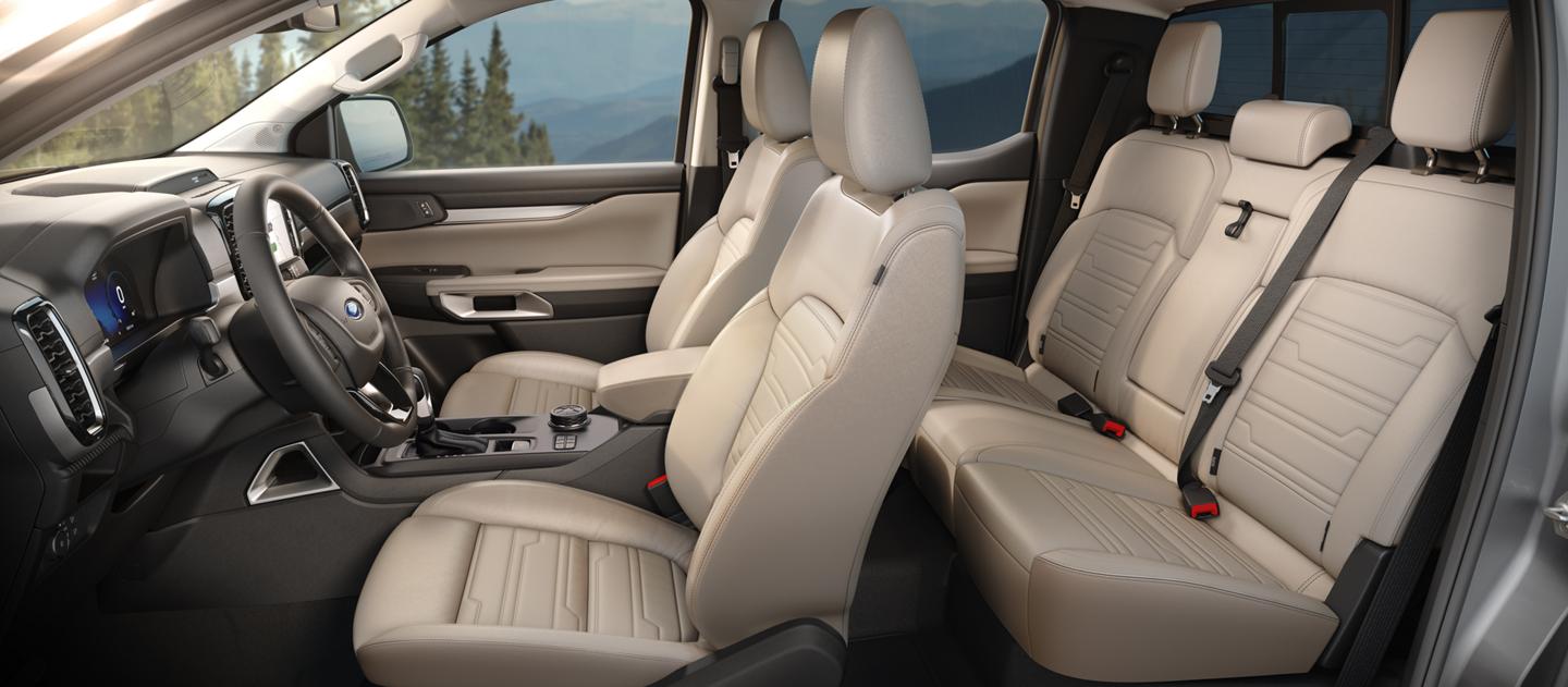 Interior view of the first and second rows inside the 2026 Ford Ranger® Lariat® in the color Sand Stone