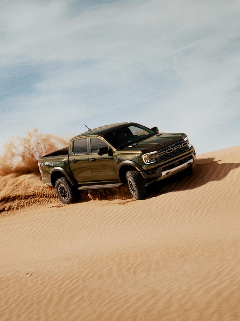 2026 Ford Ranger Raptor® truck kicking up sand while being driven on a sand dune